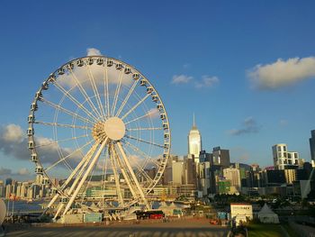 Ferris wheel in city against sky