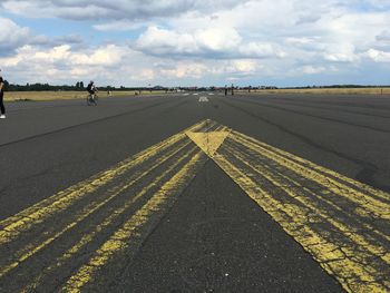 Road by landscape against sky