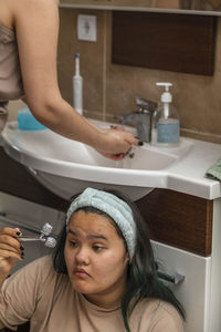 Asian beauty start their morning routine with washing and face massage in the bathroom