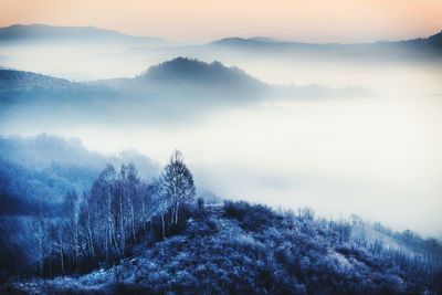 Scenic view of mountains against cloudy sky