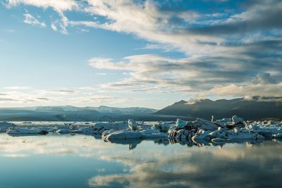 Scenic view of lake against sky during winter