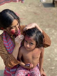 Side view of smiling young woman looking away while standing outdoors