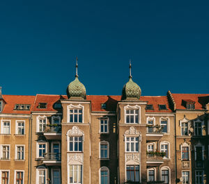 Low angle view of buildings against blue sky