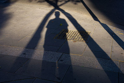 Shadow of man walking on street