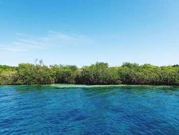 Scenic view of swimming pool by sea against sky