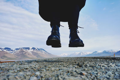 Low section of person against mountains during winter