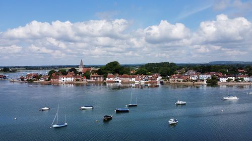 High angle view of townscape by sea against sky