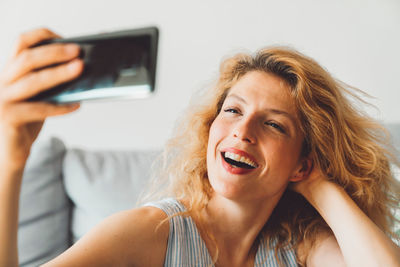 Portrait of young woman using mobile phone