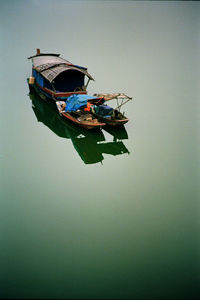 Boat in water against clear sky