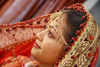 Close-up of bride with make-up looking away