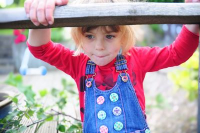 Portrait of cute girl with arms raised