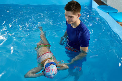 High angle view of boy swimming in pool