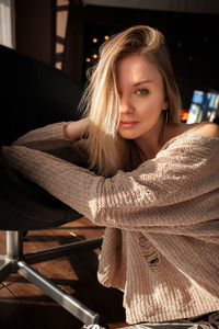 Portrait of woman sitting at home