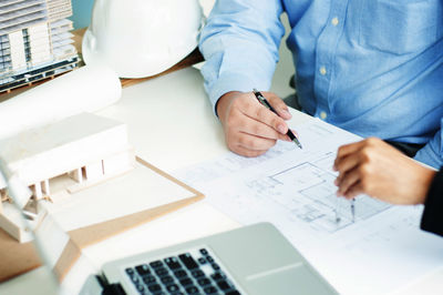 High angle view of people working on table
