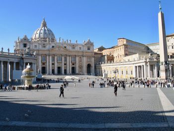 People at st. peter's basilica against clear sky