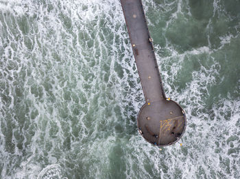 High angle view of chair by sea