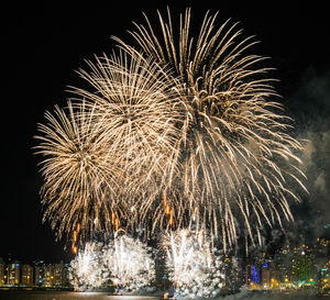 Low angle view of firework display at night