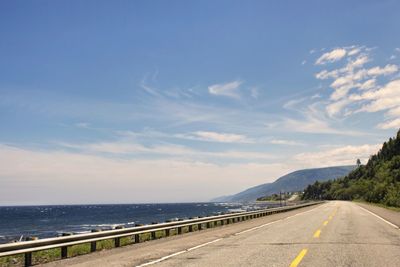 Road by sea against sky