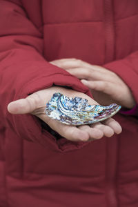 Close-up of woman holding red rose