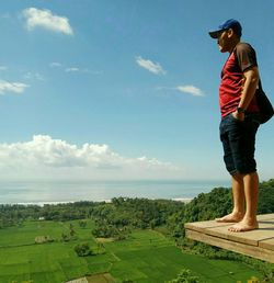 Full length of woman standing on land against sky