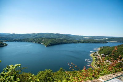 Scenic view of bay against clear blue sky