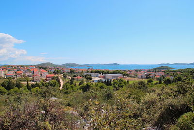 View of cityscape against blue sky