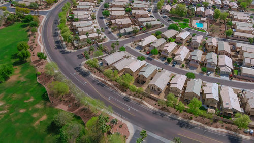 High angle view of road amidst trees in city