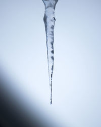 Close-up of icicles against clear sky