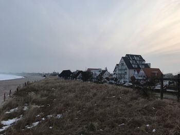 Abandoned buildings on field against sky