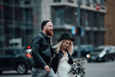 Young couple standing on street in city