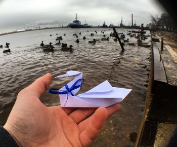 Hand holding an origami bird