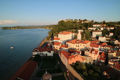 High angle view of townscape by sea against sky