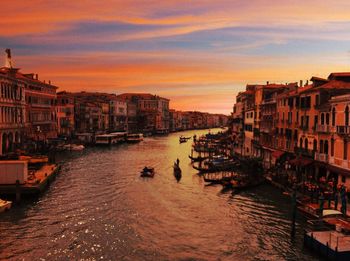 View of buildings at waterfront during sunset