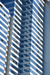 Low angle view of modern glass building in city