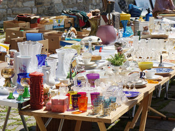 Containers arranged on table at flea market for sale