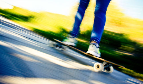 Blurred motion of man skateboarding