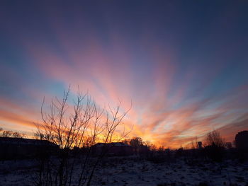 Scenic view of snow covered landscape against sky during sunset