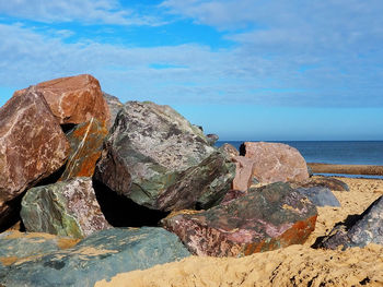 Rock formation in sea against sky