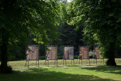 House on field against trees in forest