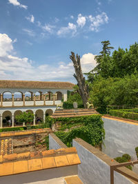 Built structure by trees against sky