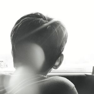 Rear view of woman looking at camera