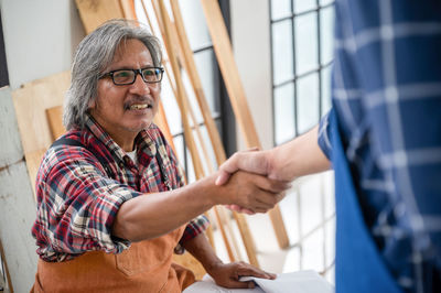 Man holding hand in workshop