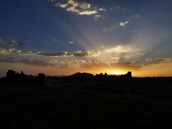 Silhouette landscape against sky during sunset