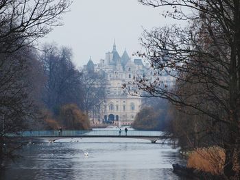 Bridge over river with buildings in background