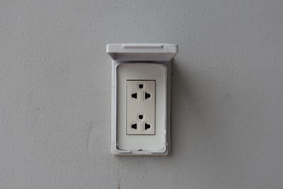 Close-up of telephone booth on wall