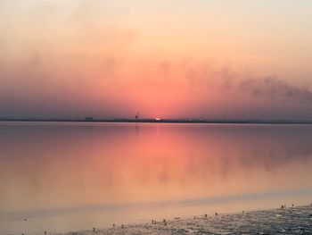 Scenic view of sea against romantic sky at sunset