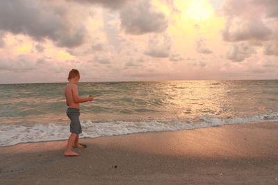 Full length of sea against sky during sunset