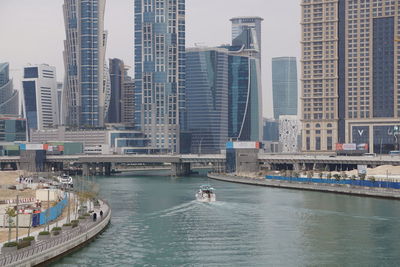 Panoramic view of bay and buildings against sky