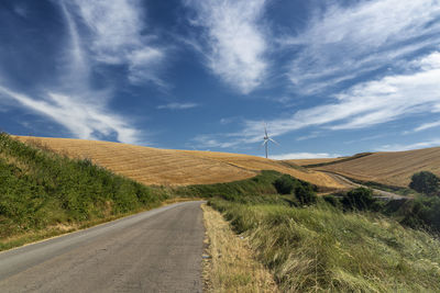 Road by land against sky