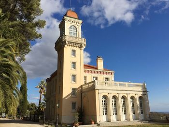 Low angle view of historical building against cloudy sky